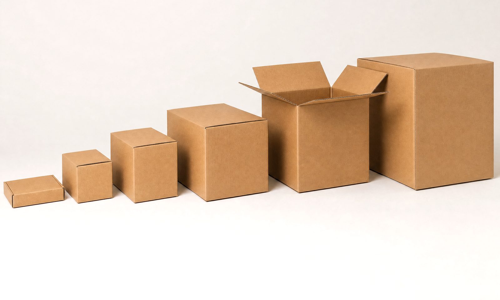 Cardboard boxes in a graduated row of sizes, from a small postal mailer up to a large double wall moving box